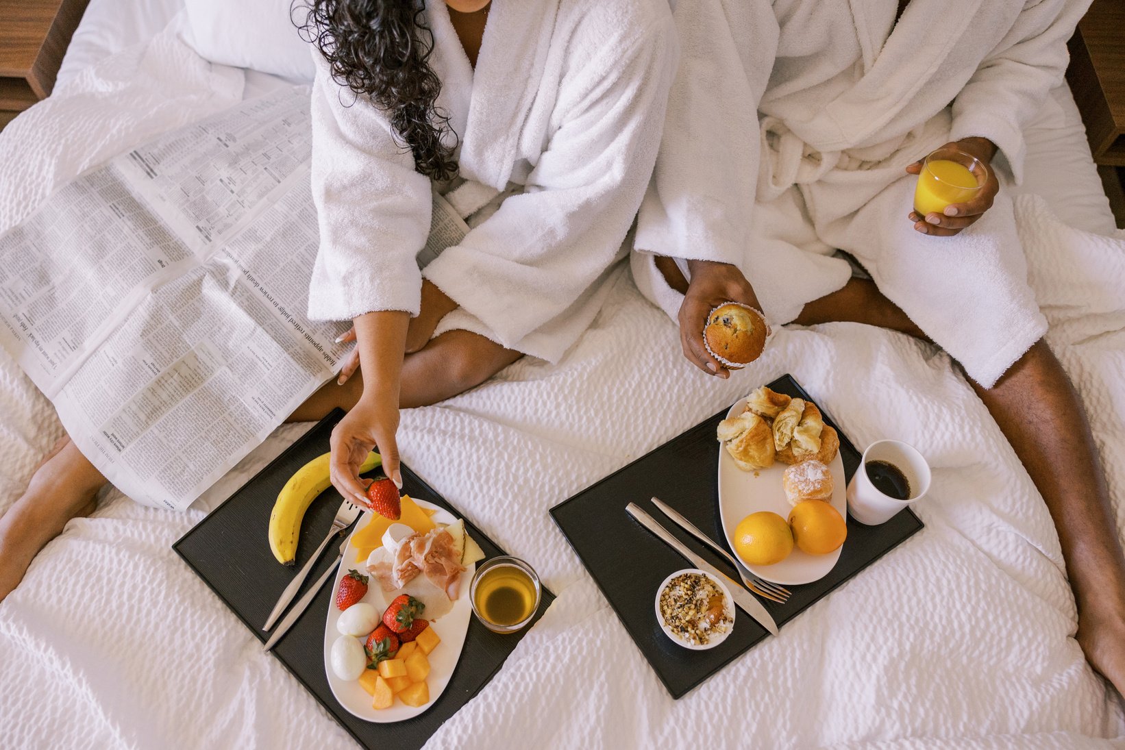 Staycation Couple Having Breakfast on Hotel Bed